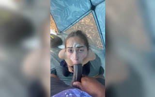 A cute Latin bitch publicly sucks a big black dick right in the tent.