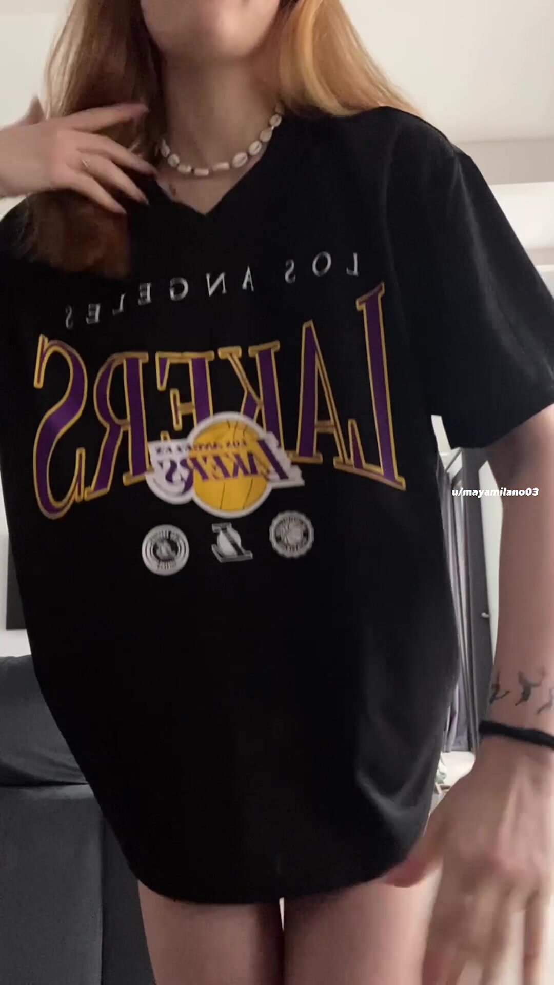 extralarge shirt hides a petite tattooed girl