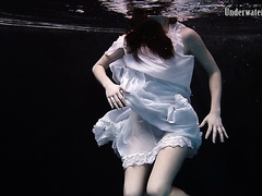 Graceful Andrejka strips her dress off underwater